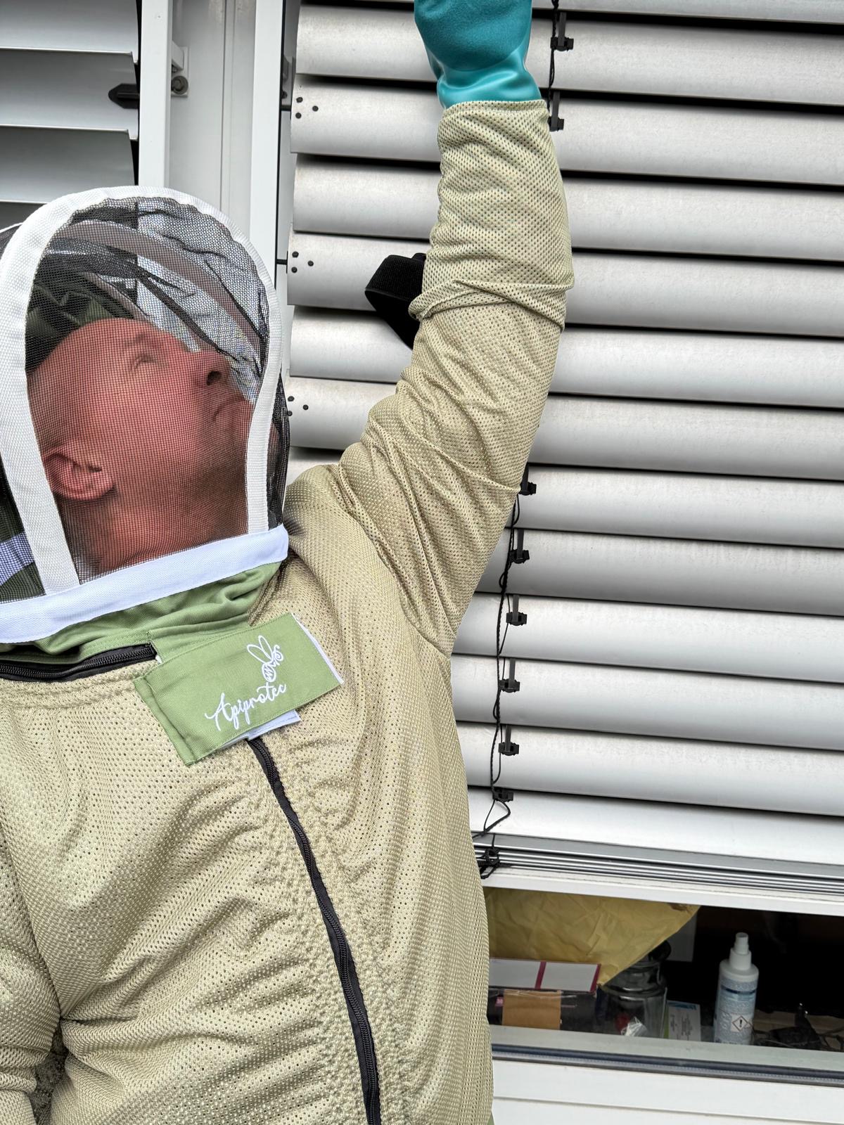 Guido Möltgen im Schutzanzug bei der Entfernung eines Wespennests an einem Rollladenkasten